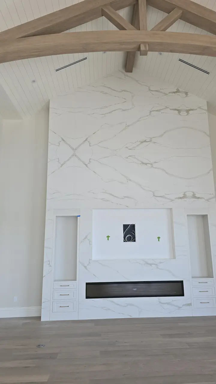 New custom home with a 25-foot porcelain fireplace wall and a master bath with a stone tub