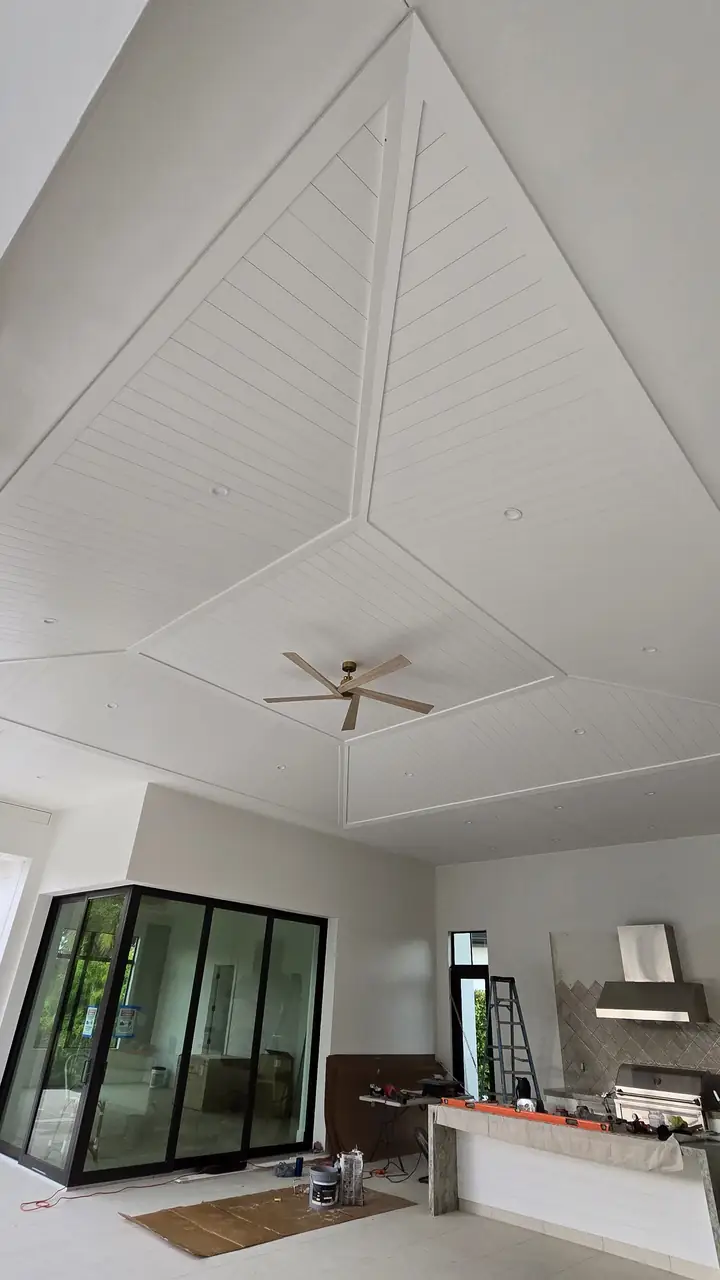 White wood plank tray ceiling with a ceiling fan